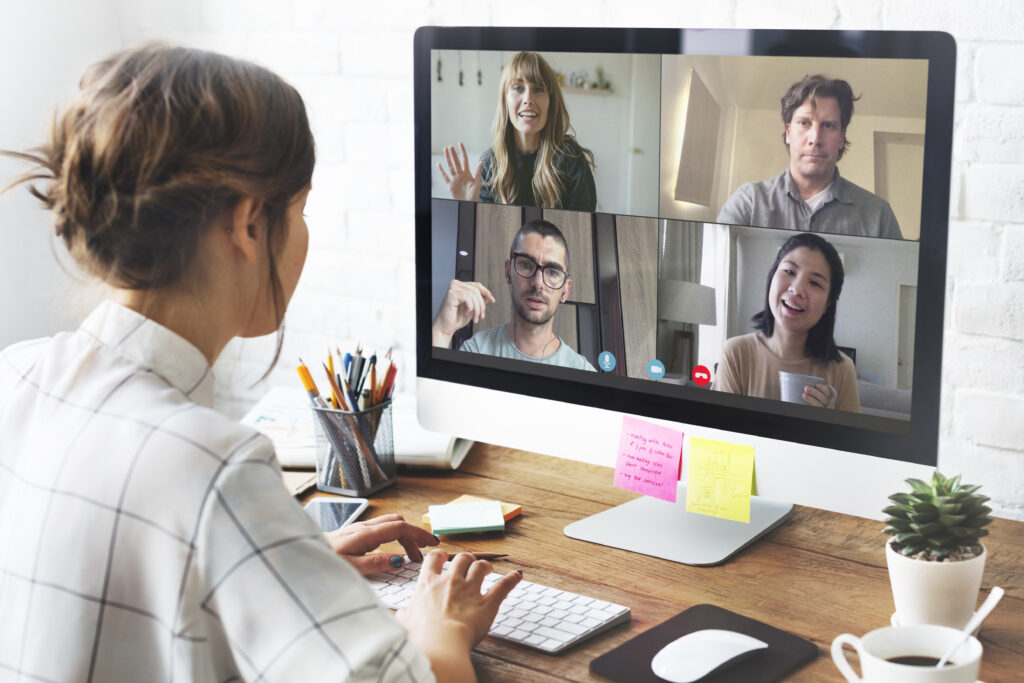 women looking into camera while doing virtual meeting